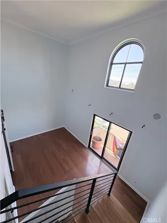 a view of room with wooden floor and fan