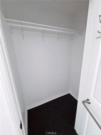 a view of closet with wooden floor