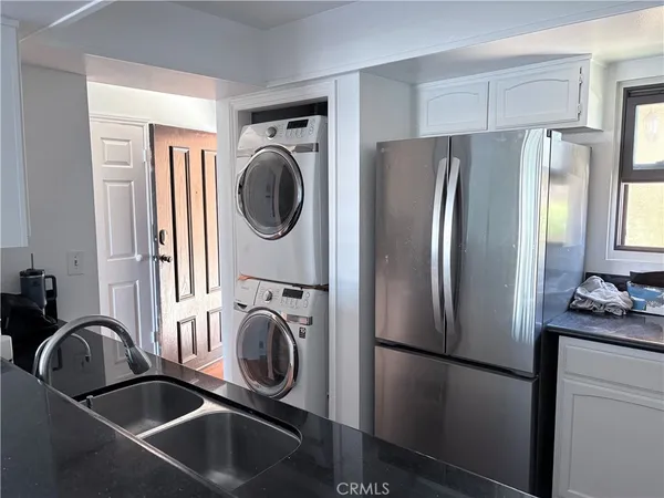 a kitchen with a refrigerator and a sink