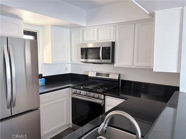 a kitchen with cabinets and appliances