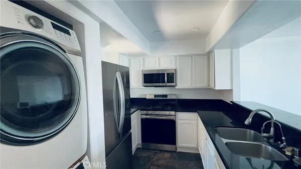a kitchen with a refrigerator and a sink