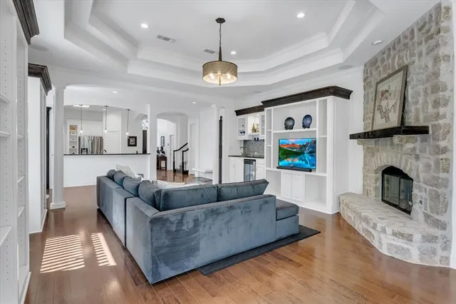 a living room with furniture a fireplace and a chandelier