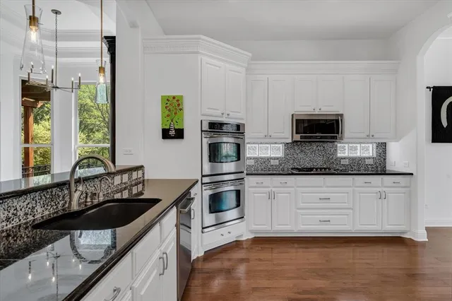 a kitchen with a sink stove and microwave