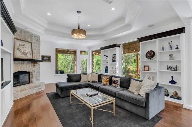 a living room with furniture a fireplace and a large window