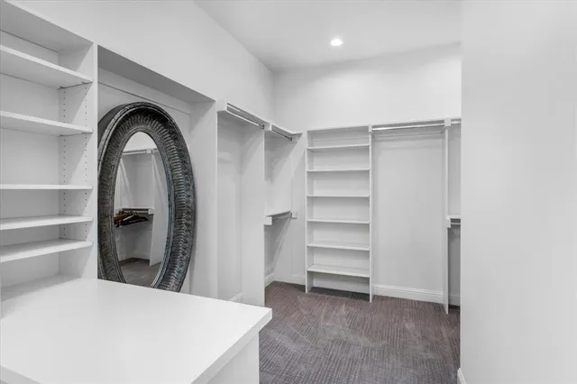 a view of a bedroom with closet and window