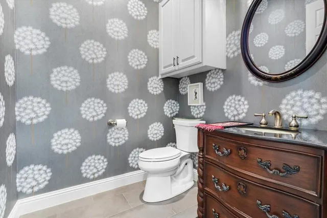 a bathroom with a toilet a sink and mirror