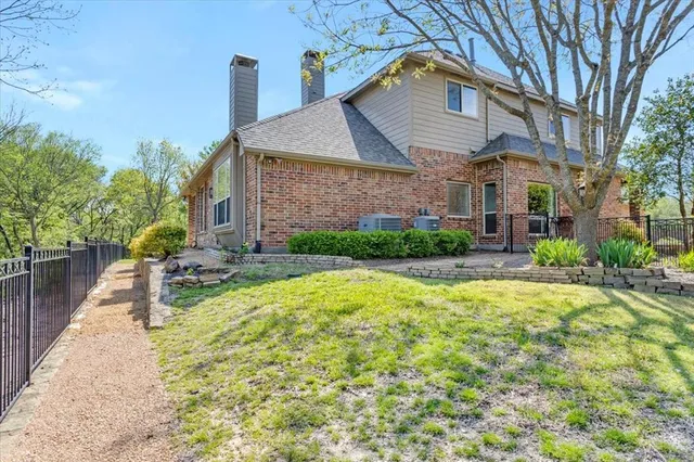 a view of a backyard with plants and patio