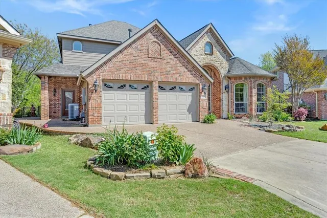 a front view of a house with a yard and potted plants