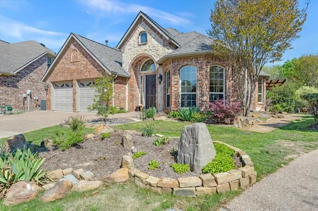 a front view of a house with a yard and potted plants