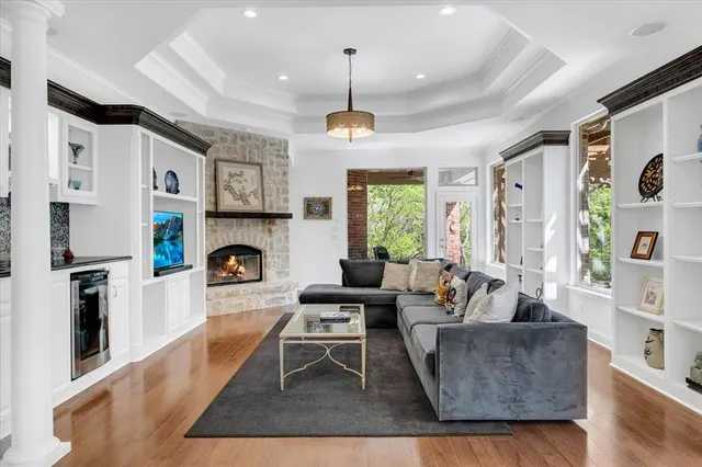a living room with furniture fireplace and a window