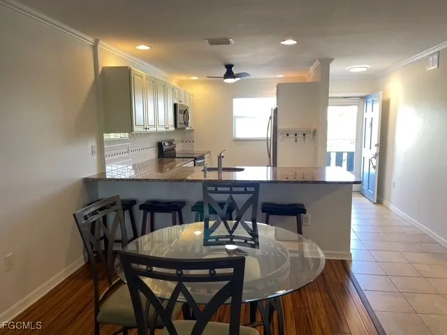 a view of a dining room with furniture and wooden floor
