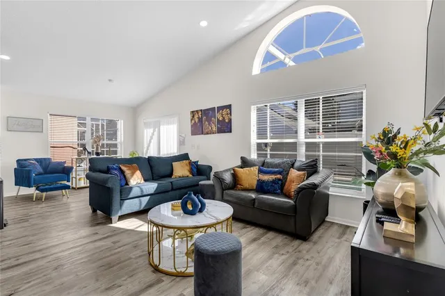 a living room with furniture a rug and a window