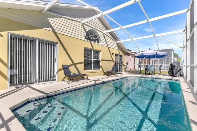 a view of a backyard with table and chairs
