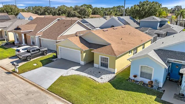 a view of a patio with couches table and chairs under an umbrella