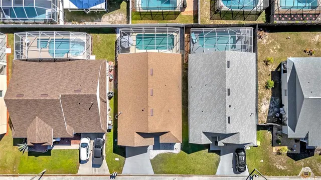 an aerial view of a house with a big yard
