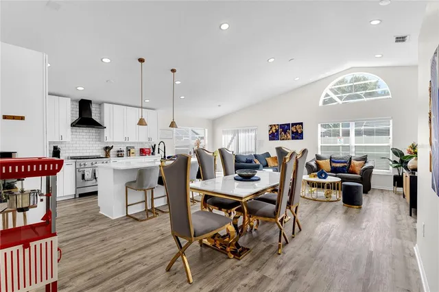 a living room with lots of furniture and kitchen view