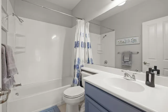 a bedroom with a bed and ceiling fan