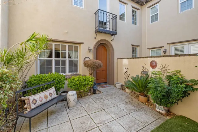 a front view of a house with a yard and a sitting area
