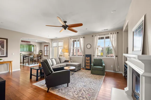 a living room with furniture and wooden floor