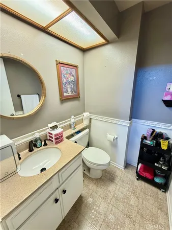 a bathroom with a sink mirror vanity and toilet
