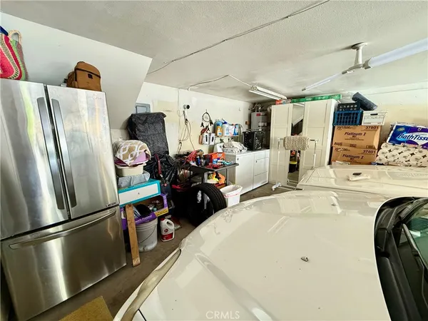a kitchen with stainless steel appliances a refrigerator and a wooden floor