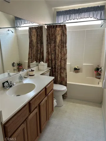 a bathroom with a double vanity sink toilet and a bathtub
