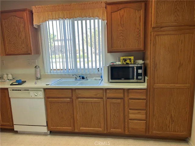 a kitchen with stainless steel appliances granite countertop a sink and a microwave