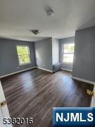 10 Westcott Street Bloomfield, NJ 07003 - Photo 12 of 17 wooden floor in an empty room with a window