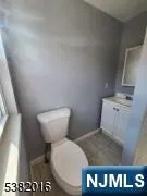 a bathroom with a toilet and a mirror