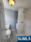 10 Westcott Street Bloomfield, NJ 07003 - Photo 14 of 17 a bathroom with a toilet and a mirror