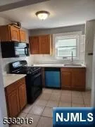 a kitchen with stainless steel appliances kitchen island granite countertop a stove a sink and a microwave