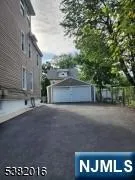 a view of a house with a yard and pathway