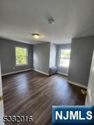 10 Westcott Street Bloomfield, NJ 07003 - Photo 10 of 17 an empty room with wooden floor and windows