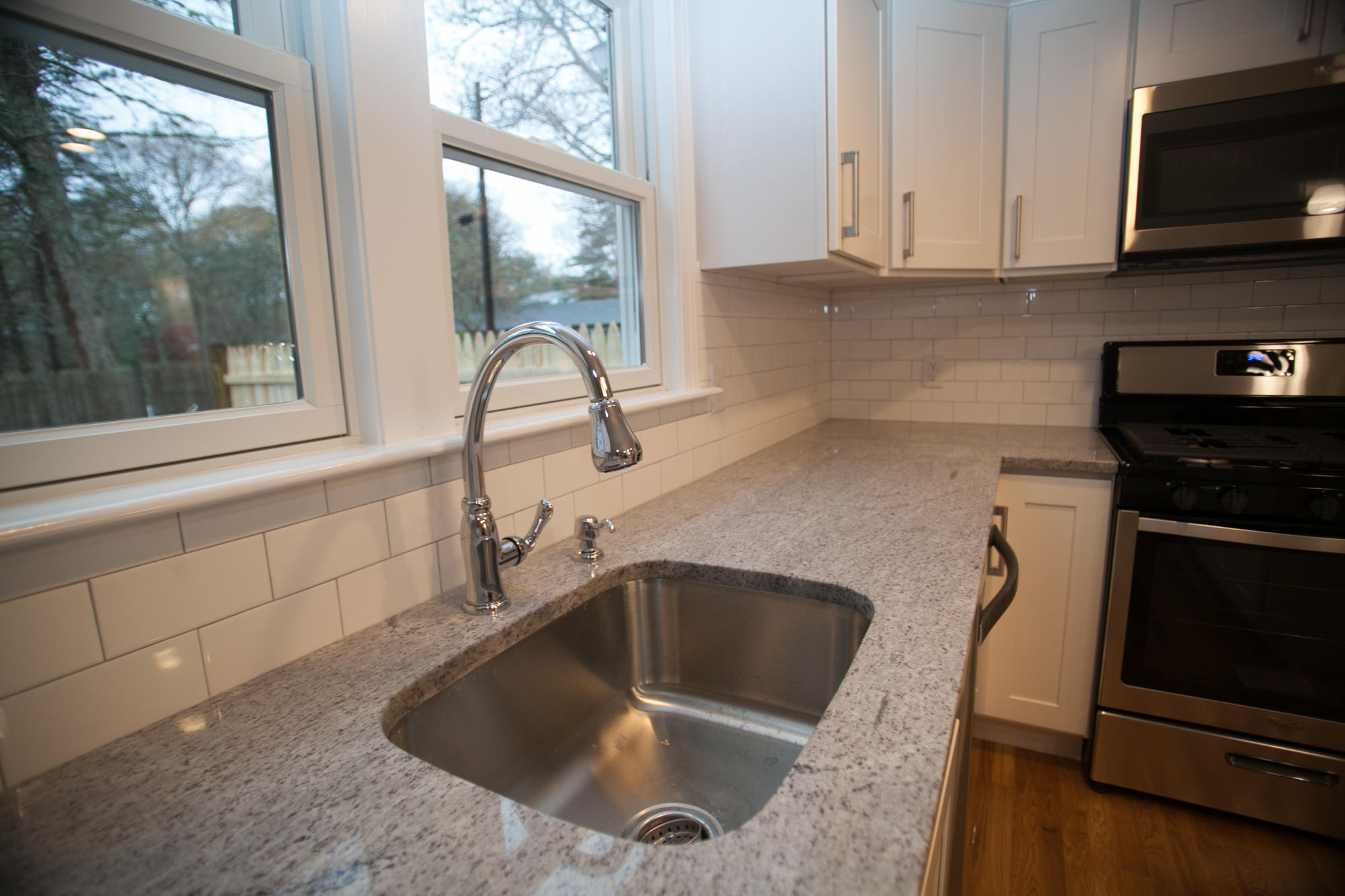 235 Old Craigville Road Hyannis, MA 02601 - Photo 13 of 35 a kitchen with granite countertop a sink and a stove top oven