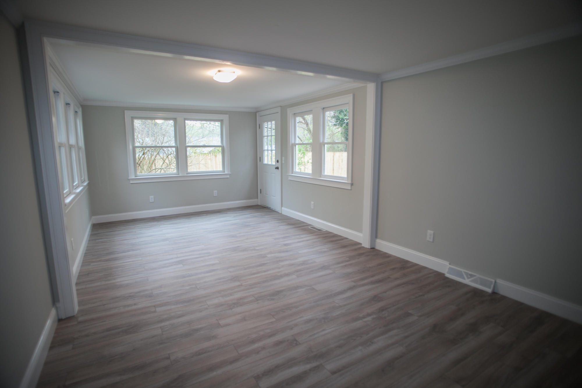 235 Old Craigville Road Hyannis, MA 02601 - Photo 17 of 35 a view of an empty room with wooden floor and a window
