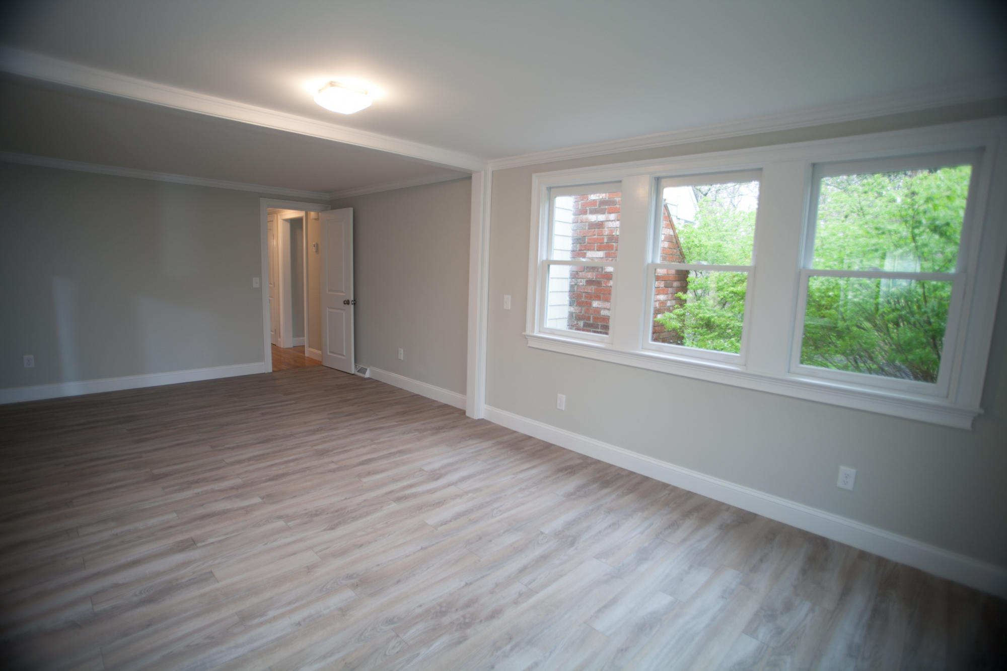 235 Old Craigville Road Hyannis, MA 02601 - Photo 18 of 35 a view of an empty room with wooden floor and a window