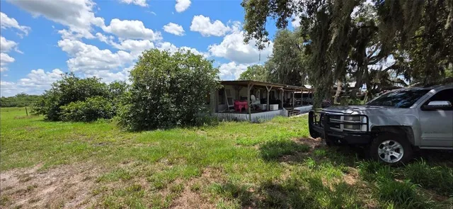a view of back yard with outdoor seating