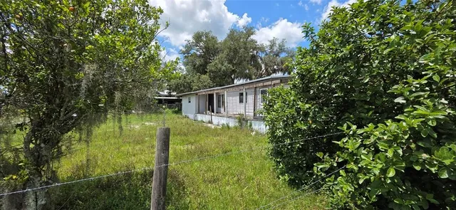 a backyard of a house with lots of green space