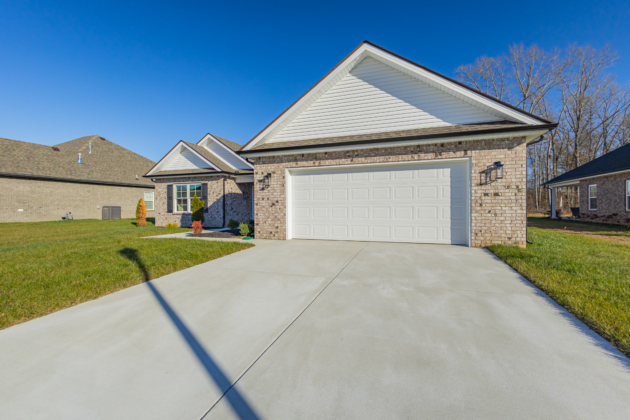 71 Brooklyn Avenue Manchester, TN 37355 - Photo 14 of 69 a front view of a house with a yard and garage
