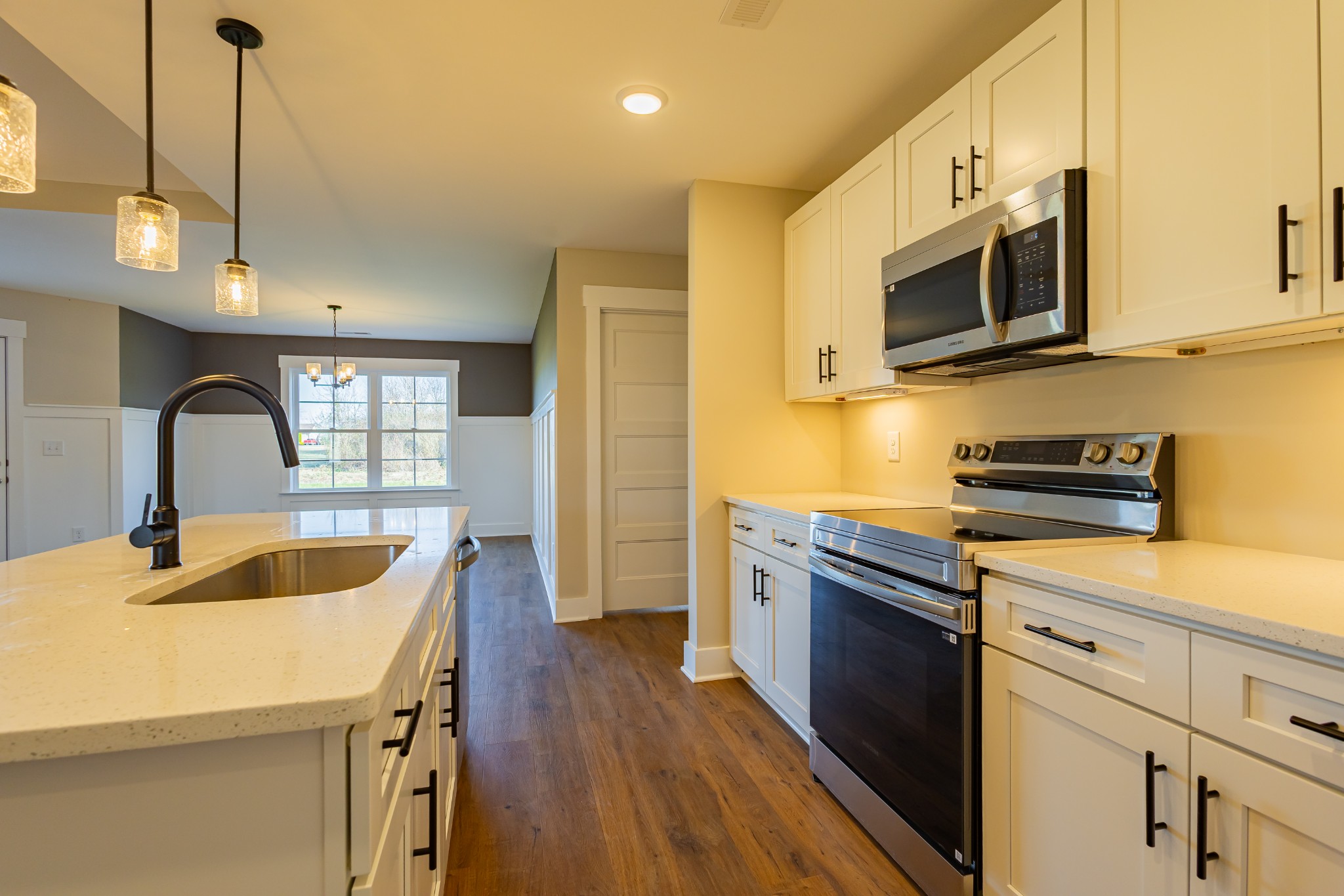 71 Brooklyn Avenue Manchester, TN 37355 - Photo 28 of 69 a kitchen with stainless steel appliances granite countertop a sink a microwave cabinets and wooden floor
