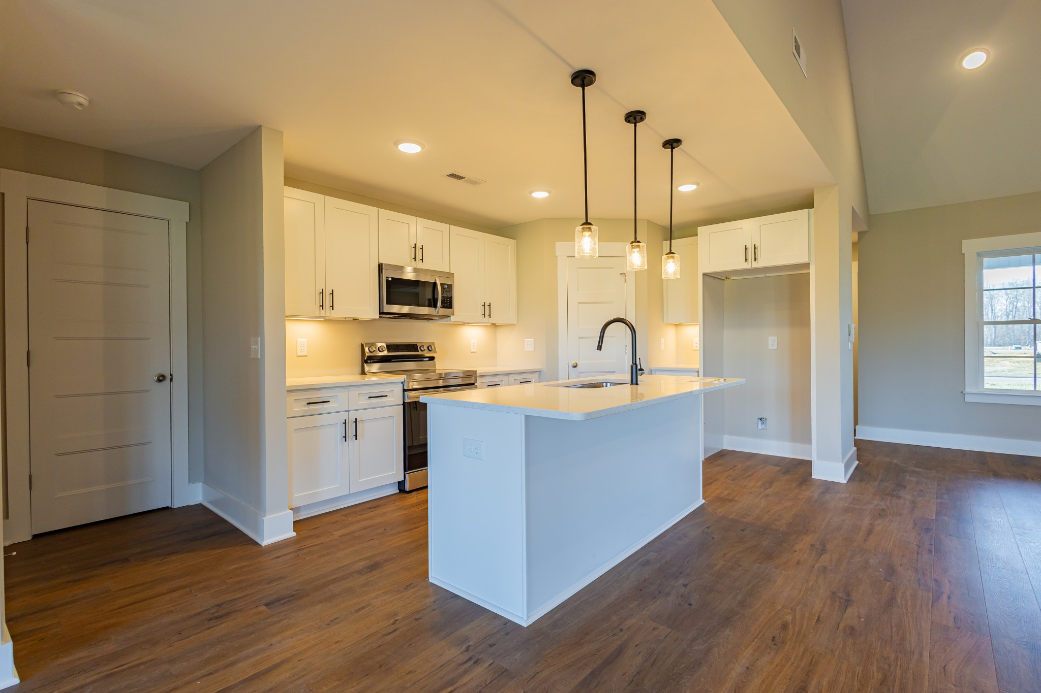71 Brooklyn Avenue Manchester, TN 37355 - Photo 32 of 69 a large kitchen with stainless steel appliances granite countertop a refrigerator a sink dishwasher a stove and a wooden floor