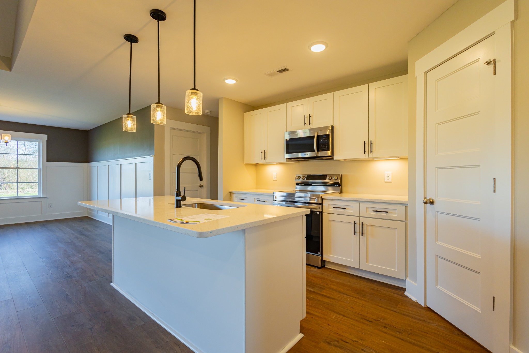 71 Brooklyn Avenue Manchester, TN 37355 - Photo 33 of 69 a kitchen with stainless steel appliances granite countertop a sink a stove a refrigerator and island with wooden floor