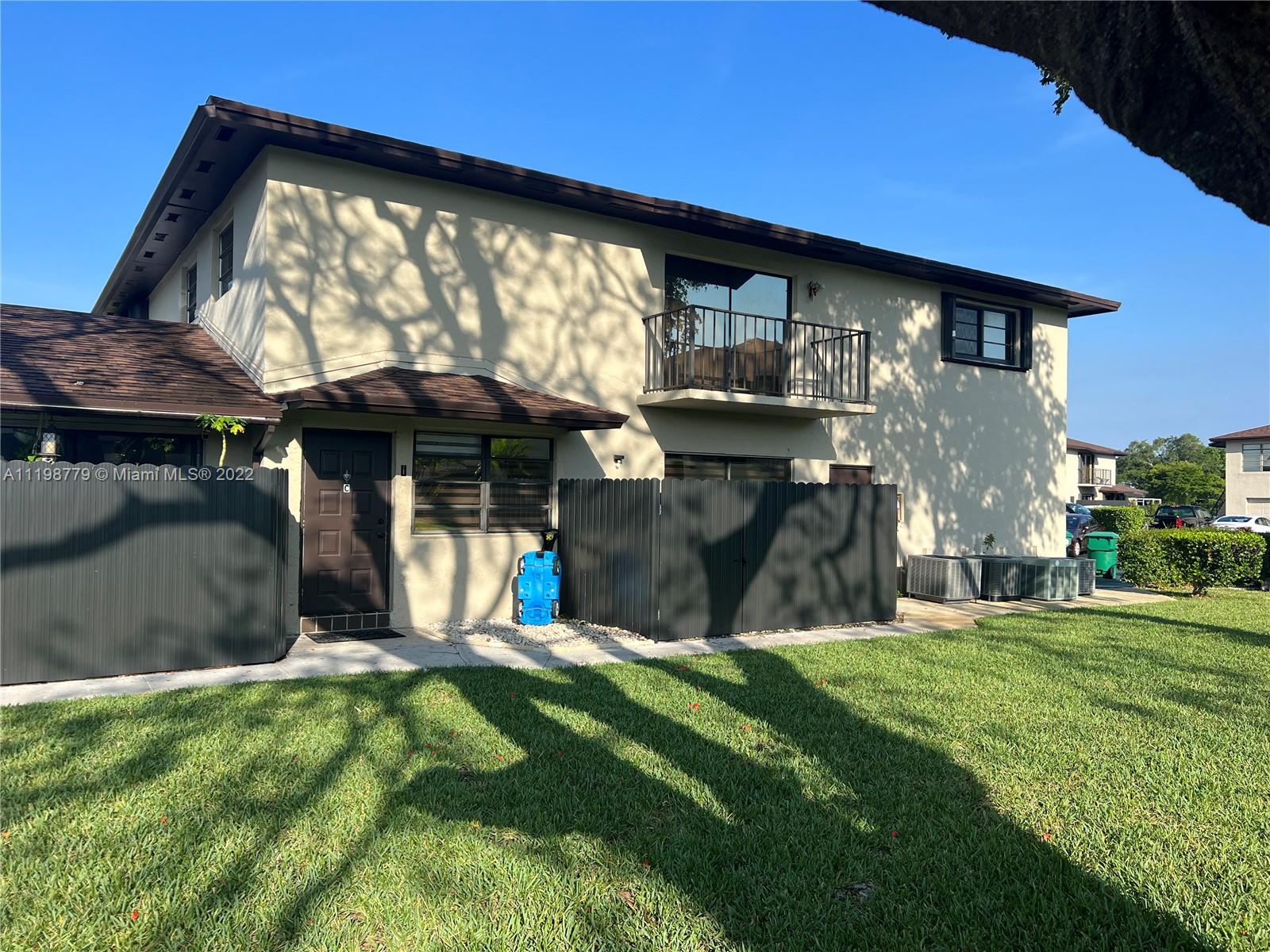 13983 Southwest 46th Terrace, Unit C Miami, FL 33175 - Photo 1 of 8 a view of a house with a yard