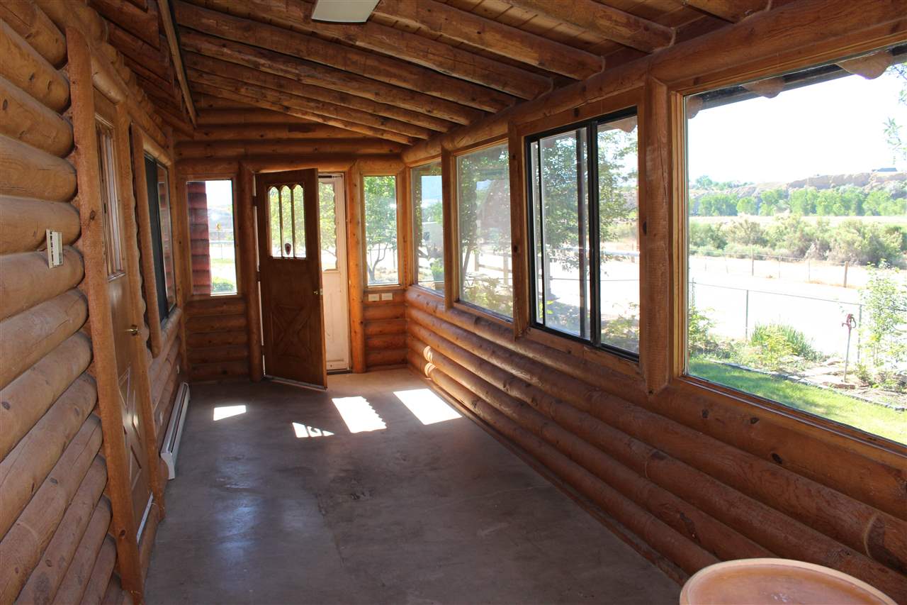 3244 D Road Clifton, CO 81520 - Photo 9 of 21 a living room with furniture and a floor to ceiling window