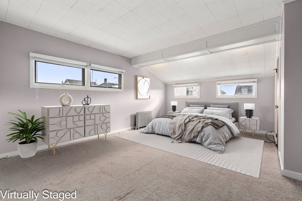 960 Shirley Street Winthrop, MA 02152 - Photo 16 of 38 a bedroom with a large bed and a potted plant