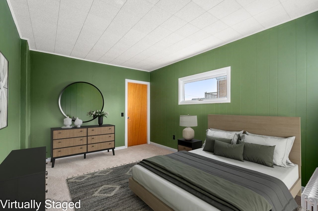 960 Shirley Street Winthrop, MA 02152 - Photo 20 of 38 a bedroom with a bed a mirror and a potted plant