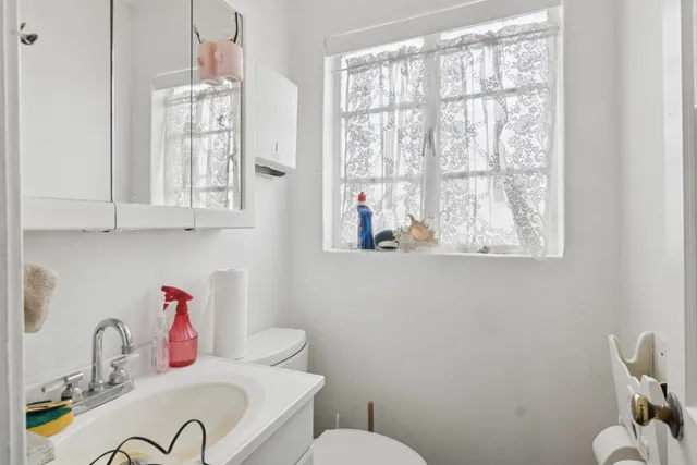 a bathroom with a sink and a window