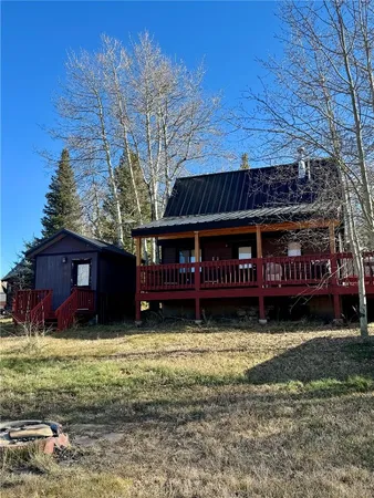 a view of a house with yard next to a road
