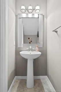 a bathroom with a sink a mirror and vanity