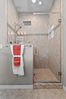 a bathroom with a glass shower door